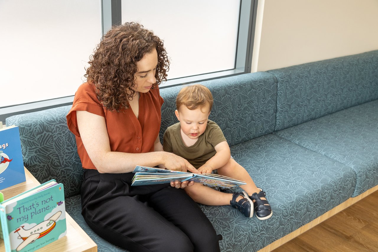 Parent reading book to child